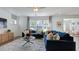 Bright living room with a plush blue sofa and a modern accent rug at 627 Contento Ct, Sanford, NC 27330