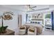 Bright main bedroom featuring a tray ceiling, contemporary artwork, and sitting area with decor at 627 Contento Ct, Sanford, NC 27330