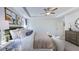 Spacious main bedroom featuring a tray ceiling, neutral decor, and a plush upholstered bed at 627 Contento Ct, Sanford, NC 27330