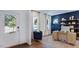 Office space showcasing wood floors, a blue accent wall, white trim, and a desk at 627 Contento Ct, Sanford, NC 27330