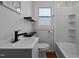 Stylish bathroom features a modern vanity, floating shelves, and tub-shower combo at 704 Dothan Ave, Burlington, NC 27217