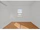Bright bedroom features wood floors, white walls and trim, plus window with view at 704 Dothan Ave, Burlington, NC 27217