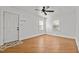 Bright room with hardwood floors, ceiling fan and two large windows providing natural light at 704 Dothan Ave, Burlington, NC 27217