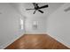 Bedroom with hardwood floors, light walls, a ceiling fan, an air conditioner, and natural light at 704 Dothan Ave, Burlington, NC 27217