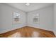 Empty bedroom with neutral tones and two large windows at 704 Dothan Ave, Burlington, NC 27217