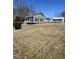 Charming single-story home with gray siding, black shutters, and a well-maintained front yard at 704 Dothan Ave, Burlington, NC 27217