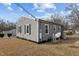 Home exterior features gray siding, white trim, and a well-maintained yard at 704 Dothan Ave, Burlington, NC 27217