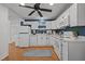 Well-lit kitchen featuring white appliances, ample counter space, and wood-look flooring at 704 Dothan Ave, Burlington, NC 27217
