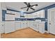 Bright kitchen features white cabinetry, modern appliances, and beautiful, contrasting blue accent wall at 704 Dothan Ave, Burlington, NC 27217