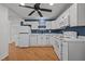 Well-lit kitchen with white appliances, ample counter space, and wood-look flooring at 704 Dothan Ave, Burlington, NC 27217