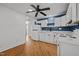 Bright kitchen features white cabinetry, modern appliances, and beautiful, contrasting blue accent wall at 704 Dothan Ave, Burlington, NC 27217