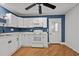 Bright kitchen features white cabinetry, modern appliances, and door to the exterior at 704 Dothan Ave, Burlington, NC 27217