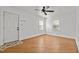 Inviting room with wood flooring, white walls, and a ceiling fan above at 704 Dothan Ave, Burlington, NC 27217