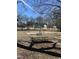 Neighborhood park features mature trees, playground with swing set, and picnic tables at 704 Dothan Ave, Burlington, NC 27217