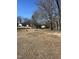 A scenic park features a playground and seating amid a tranquil, wooded setting at 704 Dothan Ave, Burlington, NC 27217