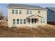 The home's back exterior features a covered patio, yard, and many windows for natural light at 800 Tree Green Ln, Wake Forest, NC 27587