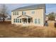 The back of this two-story home has a covered patio, large yard, and many windows at 800 Tree Green Ln, Wake Forest, NC 27587
