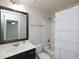 This bathroom includes a combination tub and shower, marble countertops, and modern hardware at 800 Tree Green Ln, Wake Forest, NC 27587