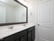 Bathroom featuring double vanity with framed mirror and white cabinets at 800 Tree Green Ln, Wake Forest, NC 27587