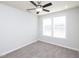 Carpeted bedroom with a ceiling fan, window providing natural light, and neutral paint at 800 Tree Green Ln, Wake Forest, NC 27587