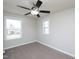 Well-lit bedroom features plush carpeting and a modern ceiling fan, complemented by natural light from two windows at 800 Tree Green Ln, Wake Forest, NC 27587