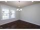 Bright dining room with hardwood floors, a modern chandelier, and large windows at 800 Tree Green Ln, Wake Forest, NC 27587