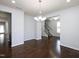 Dining area featuring hardwood floors, fresh paint, and a modern chandelier at 800 Tree Green Ln, Wake Forest, NC 27587