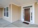 Inviting front porch featuring a dark wood door, sidelights, and white trim at 800 Tree Green Ln, Wake Forest, NC 27587