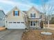 Charming home featuring a two-car garage, a well-manicured lawn, and a welcoming front porch at 800 Tree Green Ln, Wake Forest, NC 27587