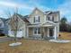 Charming home featuring a two-car garage, a well-manicured lawn, and a welcoming front porch at 800 Tree Green Ln, Wake Forest, NC 27587