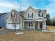 Charming home featuring a two-car garage, a well-manicured lawn, and a welcoming front porch at 800 Tree Green Ln, Wake Forest, NC 27587