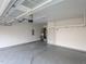 Spacious garage features ample room for parking, with overhead storage racks and a modern door opener at 800 Tree Green Ln, Wake Forest, NC 27587