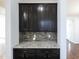 Kitchen features dark cabinets, mosaic backsplash, and granite countertops at 800 Tree Green Ln, Wake Forest, NC 27587
