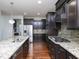 Modern kitchen with granite counters, a gas range, stainless steel appliances, and wood floors at 800 Tree Green Ln, Wake Forest, NC 27587