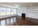 Bright living room with a fireplace, built-in shelves, hardwood floors, and large windows at 800 Tree Green Ln, Wake Forest, NC 27587