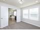 Bright main bedroom boasts abundant natural light, modern lighting and an ensuite bathroom at 800 Tree Green Ln, Wake Forest, NC 27587