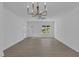 Bright living room with gray flooring, a modern ceiling fan, and large windows at 873 Jasmine Rd, Fuquay Varina, NC 27526