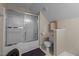 Cozy bathroom featuring vanity with sink, toilet and tub with sliding glass door at 886 Drogheda Pl, Wake Forest, NC 27587