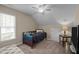 Well-lit bedroom with a ceiling fan, carpet, dresser, nightstand and full-sized bed at 886 Drogheda Pl, Wake Forest, NC 27587