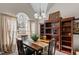 Dining room featuring a large window, chandelier, a table with seating for four, and hardwood furniture at 886 Drogheda Pl, Wake Forest, NC 27587