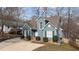 Charming two-story home with a blue exterior, well-manicured landscaping, and a concrete driveway at 886 Drogheda Pl, Wake Forest, NC 27587