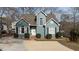 Charming two-story home with a blue exterior, well-manicured landscaping, and a concrete driveway at 886 Drogheda Pl, Wake Forest, NC 27587