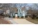 Charming two-story home with a blue exterior, well-manicured landscaping, and a concrete driveway at 886 Drogheda Pl, Wake Forest, NC 27587