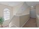 Upstairs hallway featuring natural light from a window and neutral-toned walls and carpet at 886 Drogheda Pl, Wake Forest, NC 27587