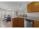 Bright kitchen features a breakfast nook, stainless steel dishwasher, granite countertops and wood cabinets at 886 Drogheda Pl, Wake Forest, NC 27587