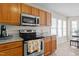Beautiful kitchen with stainless steel appliances, granite countertops, and wood cabinetry at 886 Drogheda Pl, Wake Forest, NC 27587