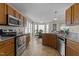 Well-equipped kitchen with stainless steel appliances, granite countertops, and wood cabinetry at 886 Drogheda Pl, Wake Forest, NC 27587