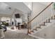 Spacious living room featuring a fireplace, vaulted ceiling, carpet flooring, and staircase access at 886 Drogheda Pl, Wake Forest, NC 27587