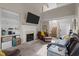 Bright living room with a fireplace, built-in shelves, comfortable seating, and a vaulted ceiling at 886 Drogheda Pl, Wake Forest, NC 27587