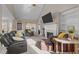 Cozy living room with a fireplace, built-in shelves, comfortable seating, and a vaulted ceiling at 886 Drogheda Pl, Wake Forest, NC 27587